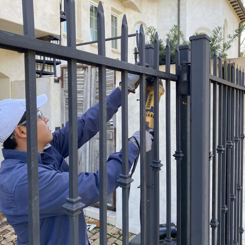 Technician performing driveway gate installation Reseda with automatic gate system
