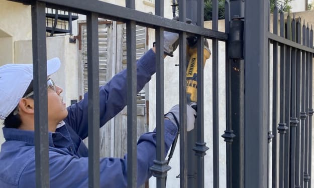 Technician performing driveway gate maintenance Reseda on automatic driveway gate system