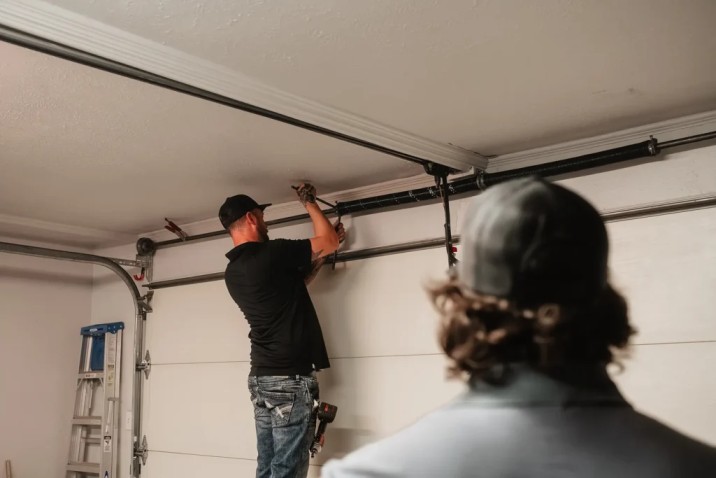 Technician performing overhead garage door repair Reseda on residential garage door system