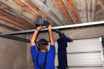 Technician performing garage door opener repair Reseda on residential garage door opener system