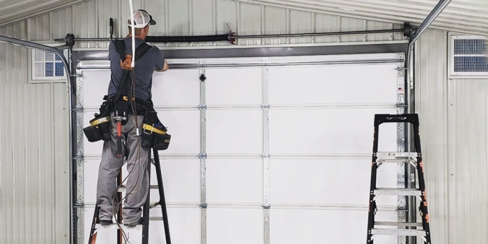 Technician performing new garage door installation Reseda on residential garage door system