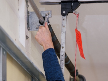 Technician performing garage door installation Reseda on residential garage door system