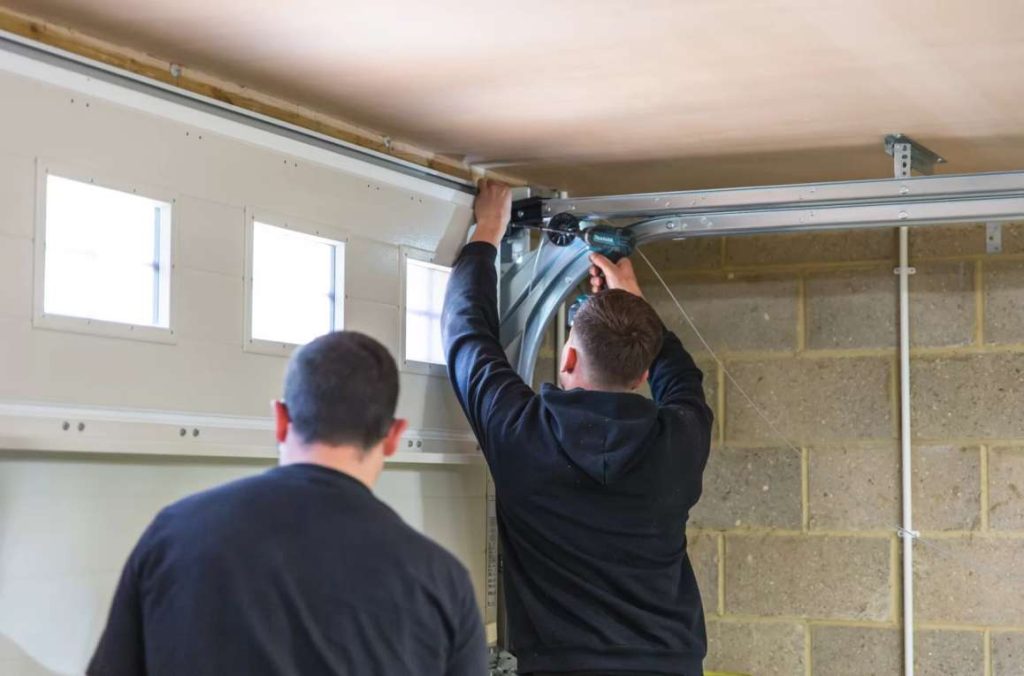 Technician performing garage door parts replacement Reseda on residential garage door system